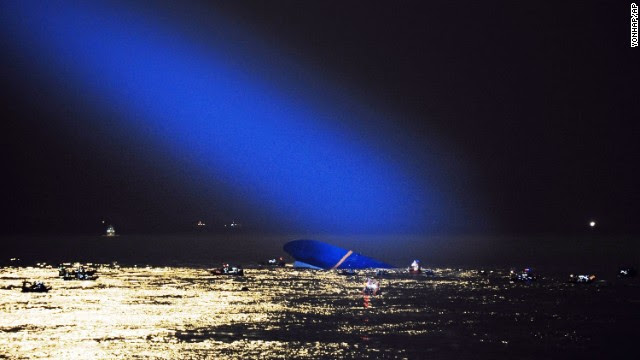 A searchlight illuminates the capsized ferry on Thursday, April 17.