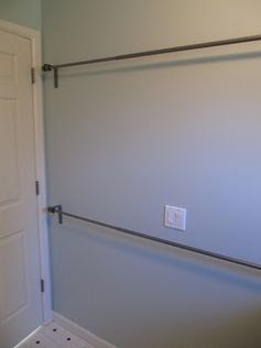 Use stacked curtain rods in laundry room to hang dry clothes...brilliant!