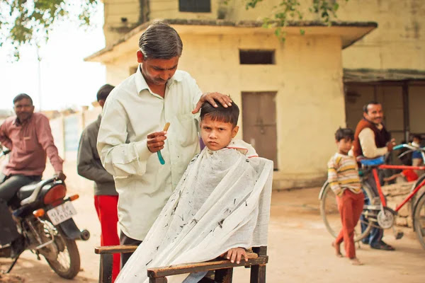 Preschool Child With Unhappy Face Doing New Hairstyle By Village Barber Stock Images Page Everypixel