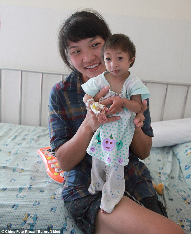 Small: With a cheeky smile and playful nature, little Liang Xiaoxiao acts just like any other child. But she could well be the world's tiniest girl