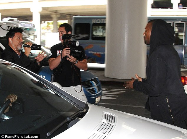 Provoked: In June 2013 Kanye was seen leaving LAX as he was surrounded by dozens of photographers, which included cameraman Daniel Ramos (far left) who got into a heated exchange with the rapper