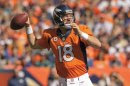 Denver Broncos quarterback Peyton Manning (18) passes the ball against the Philadelphia Eagles in the first quarter of an NFL football game, Sunday, Sept. 29, 2013, in Denver. (AP Photo/Jack Dempsey)