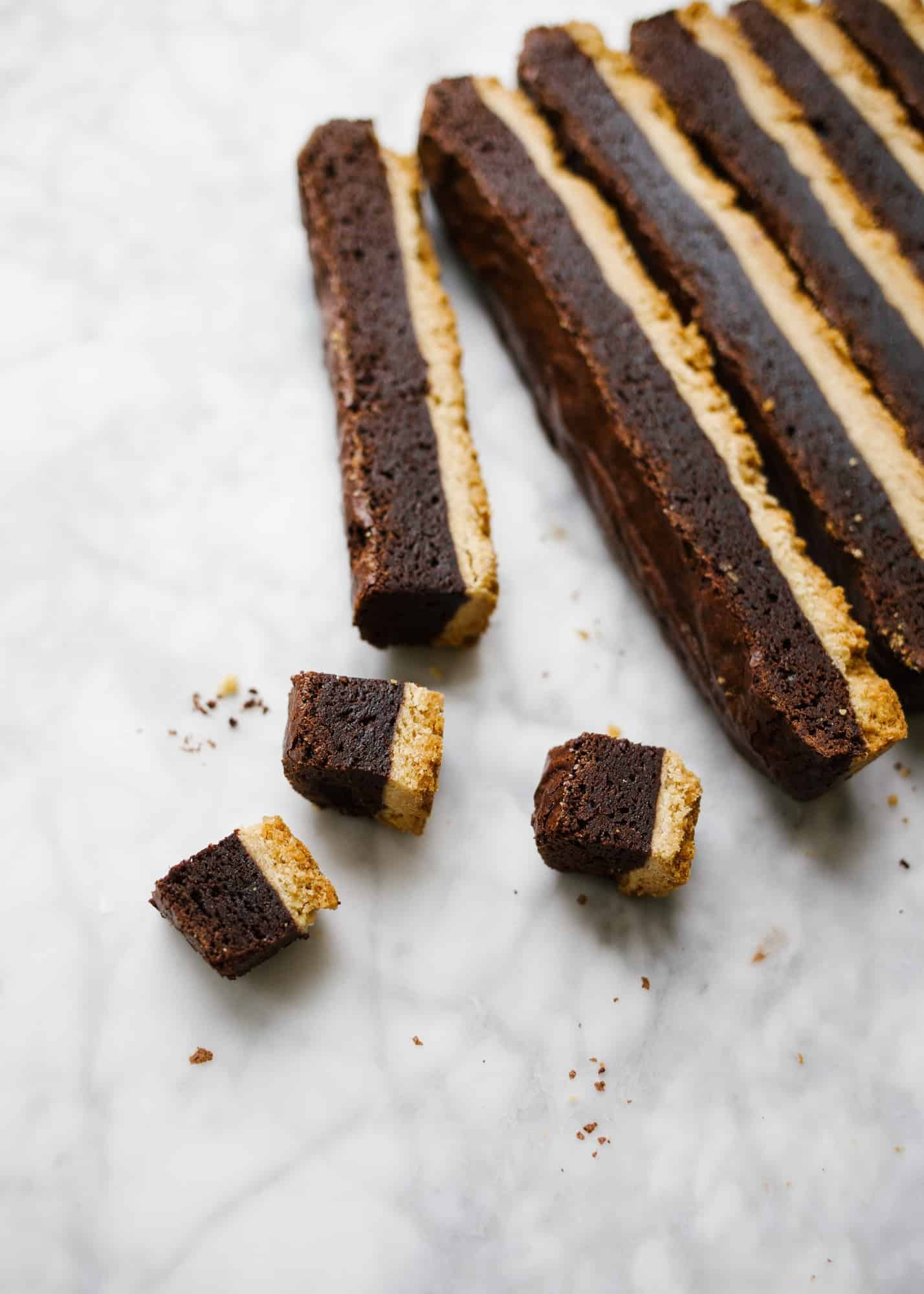 Brownie Shortbread Bars by Wood and Spoon. These are two layer bars made of a buttery vanilla bean shortbread crust and a gooey crackly top brownie. The brownie is rich and fudge without being overly dark, and the crust is crisp and tender. These bars are perfect for the shortbread lovers or for brownie lovers who love a great deal of texture! Learn how simple they are to make on thewoodandspoon.com