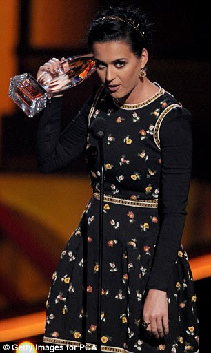 Plain Jane: Katy teamed her dress with a simple plaited hairstyle and neutral make-up 