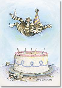 kitty about to land on a birthday cake