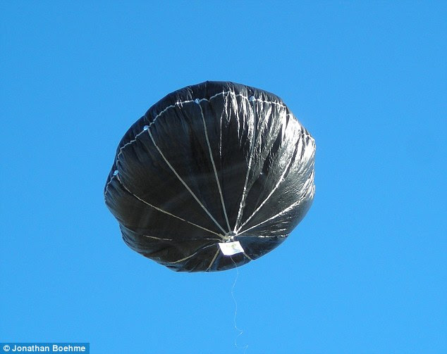 While the prospect of this being an alien spaceship is alluring, the real answer is almost certainly that it is actually a solar balloon (pictured). A solar balloon is a black or dark object that gains buoyancy by being heated by the sun's radiation