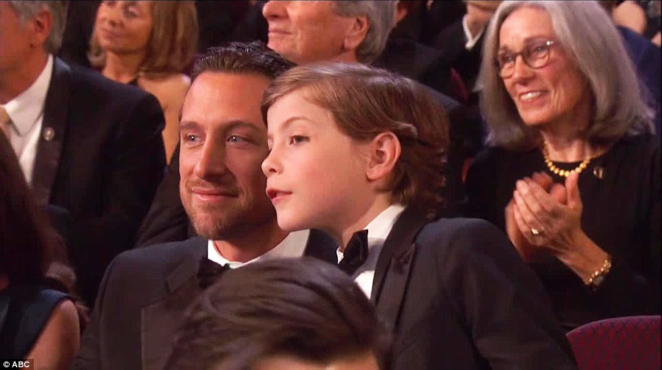 Let me see! Jacob Tremblay got out of his seat to look at the Star Wars droids