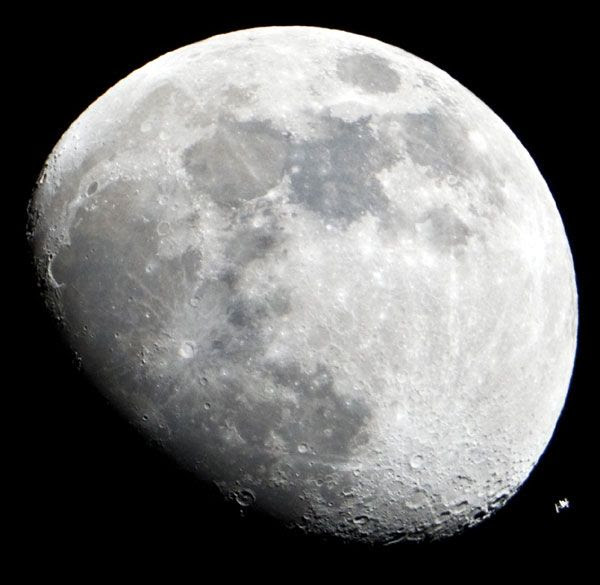 A photo of the ISS flying across the Moon's disk during the early evening of January 4, 2012.