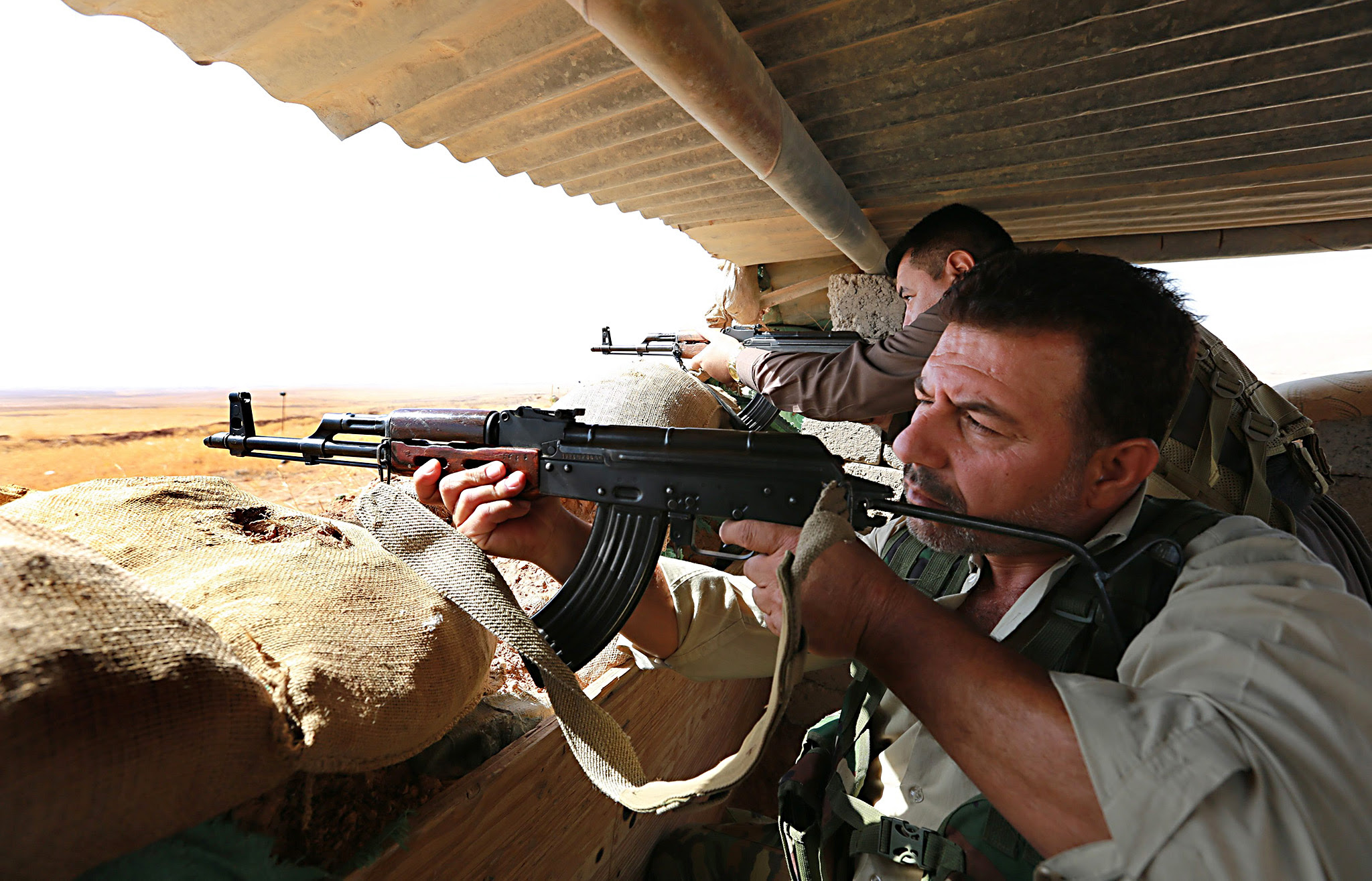 Iraqi Kurdish Peshmerga fighters aim their weapons around the town of Basheqa which remains on the frontline of fighting between Kurdish forces and militants from Islamic State (IS), 150 Km northeast of Erbil, Iraq, 10 October 2016. Media reports said Islamic State militants are isolating the inhabitants of Mosul from the outside world as the operation as the operation to liberate the northern Iraqi city from their hands seems imminent. Major General Nur al-Din Hussein, a Peshmerga Commander on the Pasheqa front line said Kurdish forces are ready for the upcoming offensive to liberate Mosul city.  EPA/AHMED JALIL