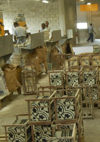 Cement tiles are placed on metal racks to dry after made