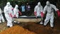 A team buries the body of a woman suspected to have