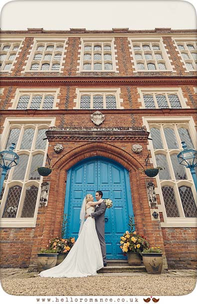 Gosfield Hall Courtyard wedding photo with bride and groom at blue door - www.helloromance.co.uk