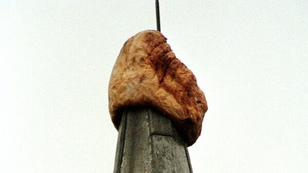 A highly weathered pumpkin sits atop the 173-foot tall McGraw Tower at Cornell University on Feb. 20, 1998, in Ithaca, N.Y. The pumpkin, estimated to weigh some 50 pounds originally was put up by unknown persons on Oct. 8, 1997, and surprised the campus by lasting through the winter.