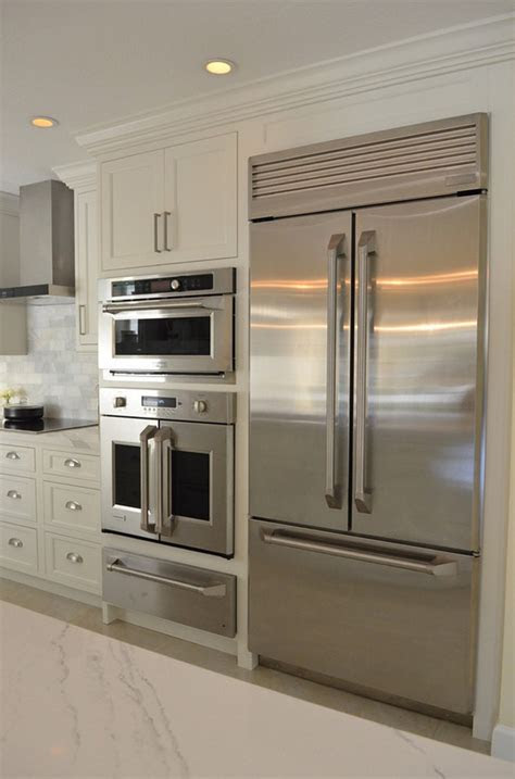 Many people are looking for freestanding options in compact sizes. White Kitchen with Driftwood Peninsula - Home Bunch
