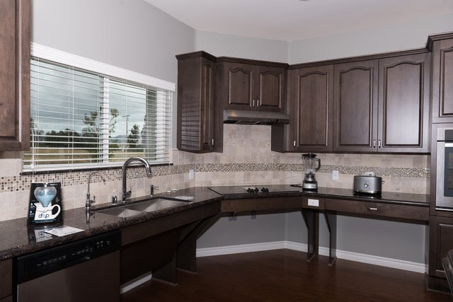 Accessible homes built by Homes For Our Troops have kitchens that allow wheelchairs to easily roll under the counters and the sink allowing disabled homeowners, like Nicholas Mendes, to cook.