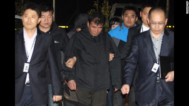 Lee Joon Suk, the captain of the Sewol, is escorted to the court that issued his arrest warrant Friday, April 18, in Mokpo, South Korea.
