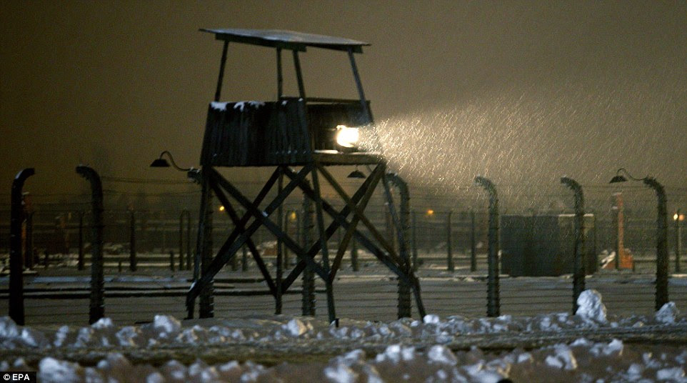 A floodlight illuminates the snow-covered area where more than one million people, mostly Jews, were killed during the Second World War