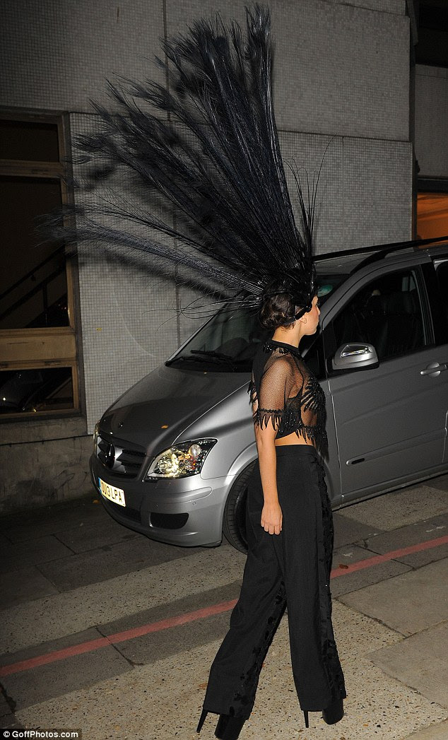 Out of this world: The 27-year-old singer appeared to have channelled a peacock when it came to her rather interesting - and revealing - choice of outfit as she arrived to film her segment on The Graham Norton Show in central London