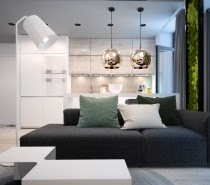 Polished brass pendant lamps coordinate with the wood cabinets and cream backsplash in the kitchen. The warm hues also provide a surprisingly pleasant contrast to the textural greenery found throughout the living room.