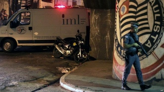 A policeman stands guard outside the Corinthians fans "Hall 9" headquarters after the shooting