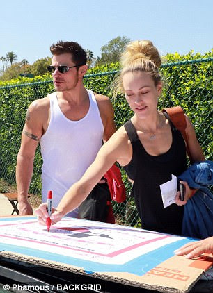 Stepping up: DWTS partner Peta Murgatroyd, 31, also signed the poster