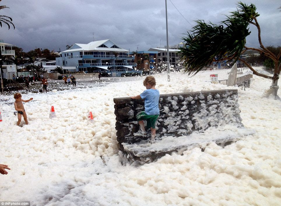  wave of frothy suds, formed during storms when powerful waves force air into the water, washed up onto shore bringing children out to play in the bubbles