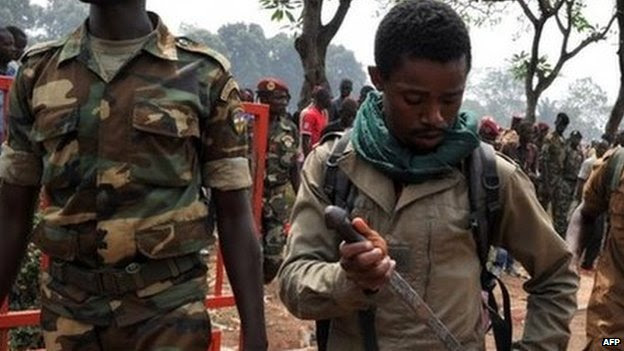 A government soldier puts his knife away after allegedly taking part in the lynching in Bangui. Photo: 5 February 2014