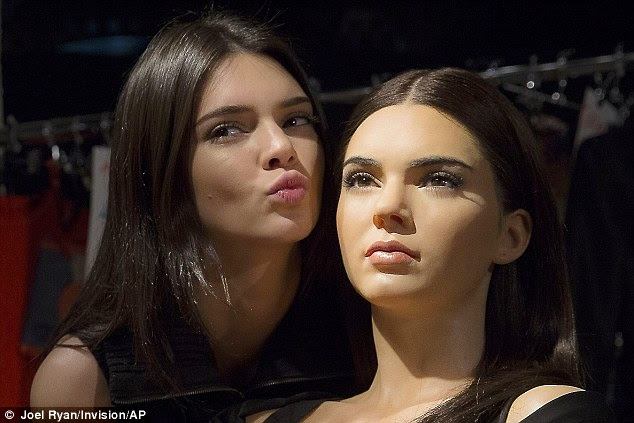 Posing up a storm: The striking beauty playfully posed alongside her stony-faced double - pouting and preening while the wax work sat immobile