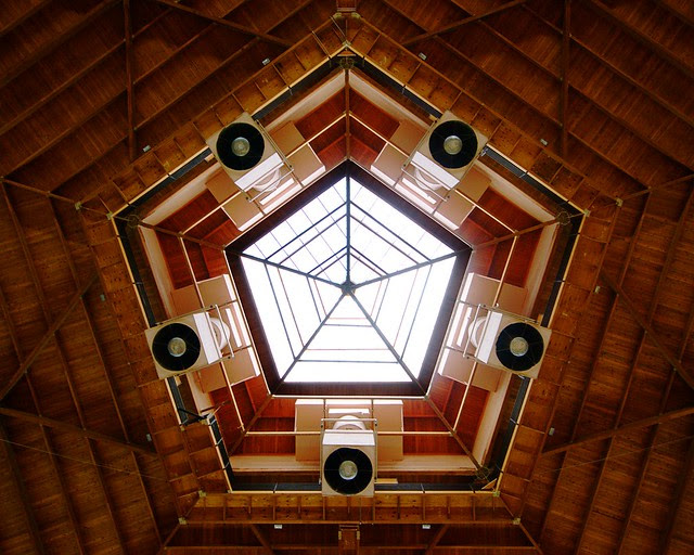 Wooden pentagons with a window in the center.