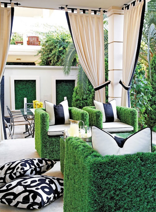 Chic patio with faux grass chairs found in paris black and white outdoor pillows, black and white outdoor curtains