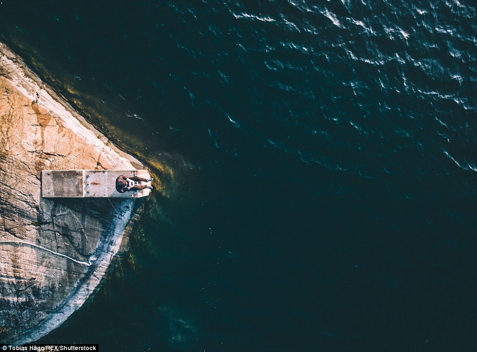 Better than a selfie: Tobias Hägg perches on a concrete block overlooking what he hopes will be a stunning sunset at Knappelskar