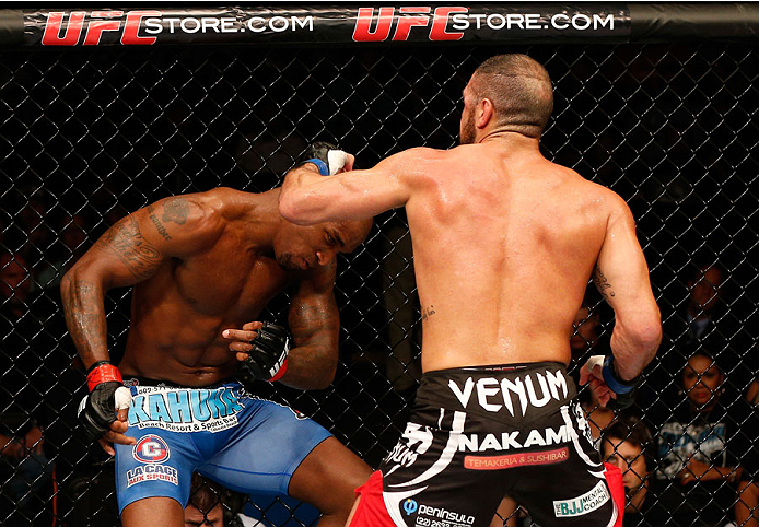 TULSA, OK - AUGUST 23:  (R-L) Thales Leites of Brazil knocks out Francis Carmont of France with a series of punches in their middleweight fight during the UFC Fight Night event at the BOK Center on August 23, 2014 in Tulsa, Oklahoma. (Photo by Josh Hedges/Zuffa LLC/Zuffa LLC via Getty Images)