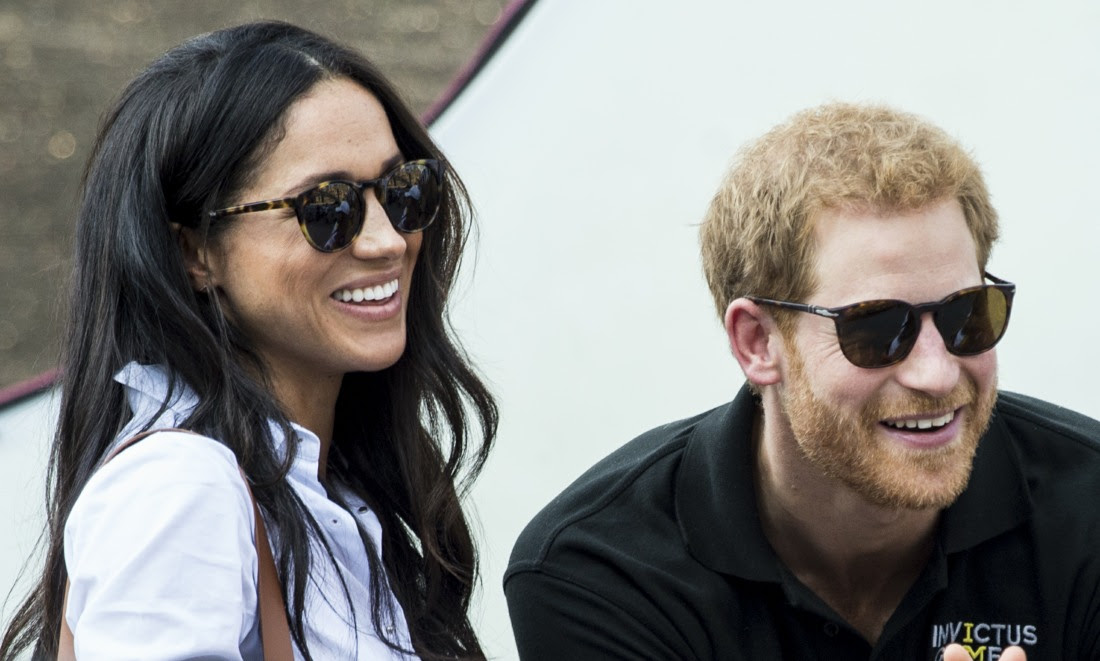 Prince Harry and his girlfriend Meghan Markle watch a wheelchair tennis match as part of the Invictus Games in Toronto