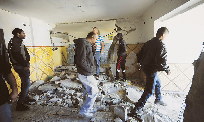 Jerusalem: Palestinians look at the debris from the demolished apartment of Abdel Rahman al Shaludi.—AP
