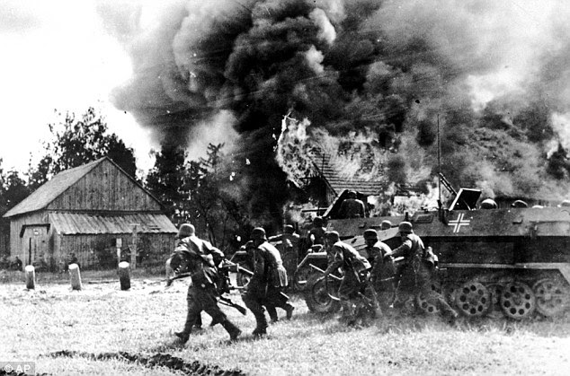 Second World War: MI5 acquired replica Iron Crosses to reward members of King's network for their loyalty to the Fuhrer. German soldiers are pictured moving into a burning Russia village in June 1941