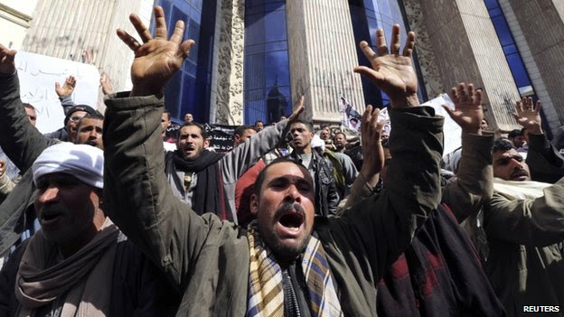 Relatives of Egyptian Coptic Christian workers hold a protest in February 2015
