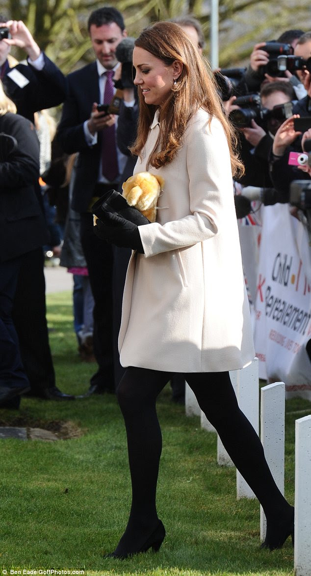 Kate kept hold of a gifted teddy bear, managing to keep mum about who she would give it to this time...