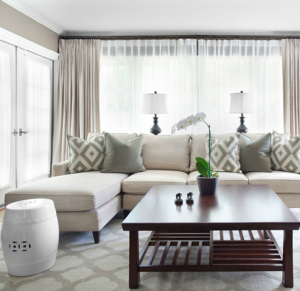 living rooms - David Hicks La Florentina gray quatrefoil patterned rug ivory sofa chaise lounge white garden stool cherry square cocktail table gray pillows oatmeal linen drapes gray walls blue lamps orchid