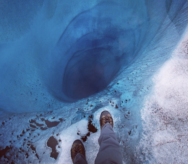 Only a sheet of ice protects you from falling a 1000 feet down this hole