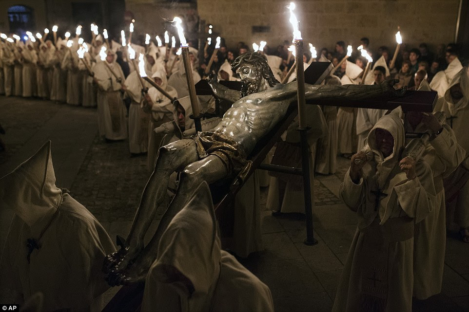 A figure of Jesus is carried through the streets of Zamora in northwest Spain by penitents from Cristo de la Buena Muerte brotherhood
