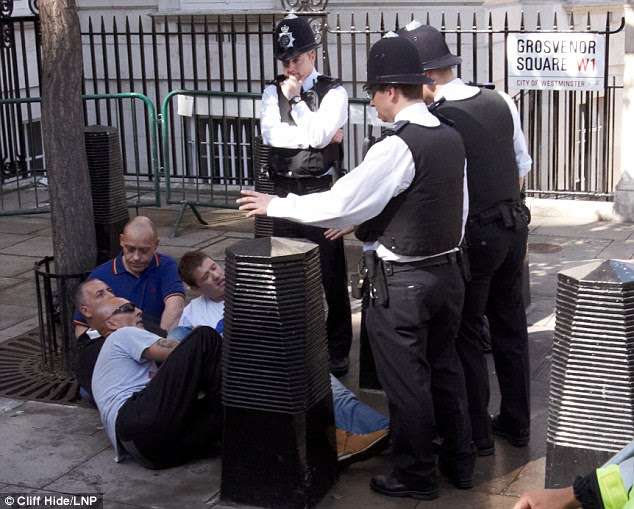 Sitting it out: Police prevent English Defence League supporters from confronting the Muslims Against Crusades protest outside the embassy