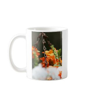 Orange flowers and rusted chain close up mug