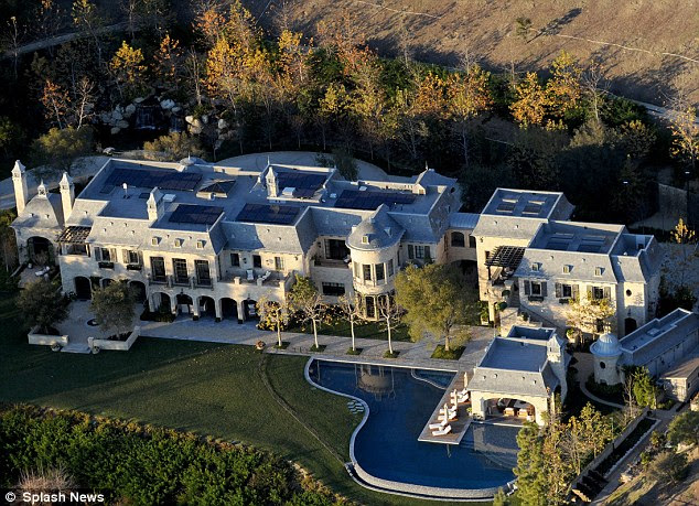 Luxurious: The 22,000-square feet property boasts eight bedrooms, a six-car garage and a lagoon-shaped swimming pool with spa
