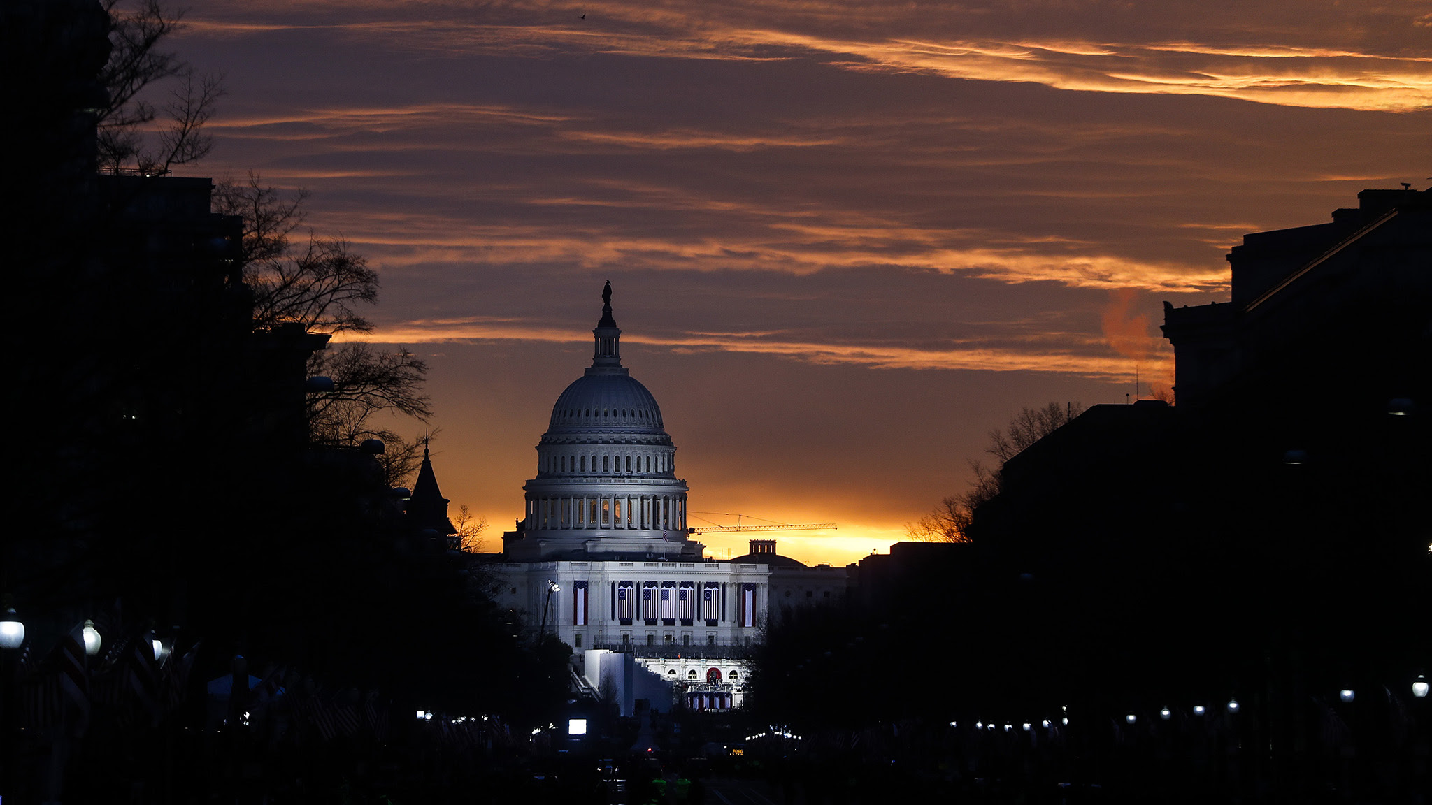 The Capitol Building is illuminated against the sunrise before the presidential inauguration of President-elect Donald Trump, Friday, Jan. 20, 2017, in Washington. (AP Photo/John Minchillo)
