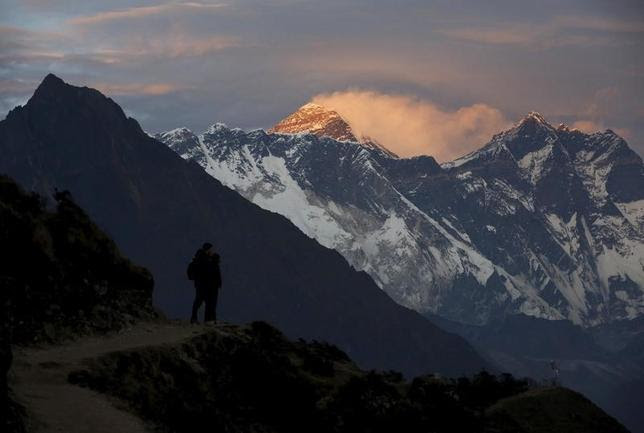 Light illuminates Mount Everest (C) during sunset in Solukhumbu district, also known as the Everest region, in this picture taken November 30, 2015. REUTERS/Navesh Chitrakar