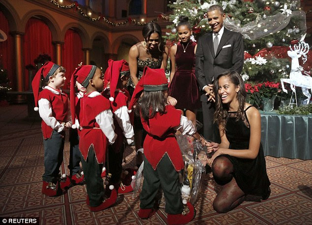 Taken: Barack and Michelle's eldest daughter, Malia, seemed particularly taken by the children 
