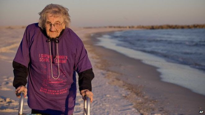 Ruby Holt walking along the beach using a frame