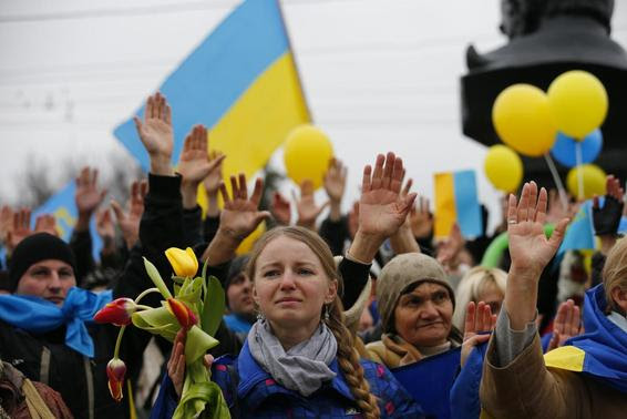 Pro-Ukrainian supporters raise their hands to symbolise a referendum and remember the victims of violence in recent protests in Kiev as they take part in a rally in Simferopol March 9, 2014. REUTERS/Thomas Peter