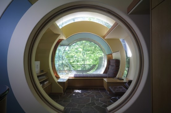 Curved Abstract House in Forest Made of Natural Materials