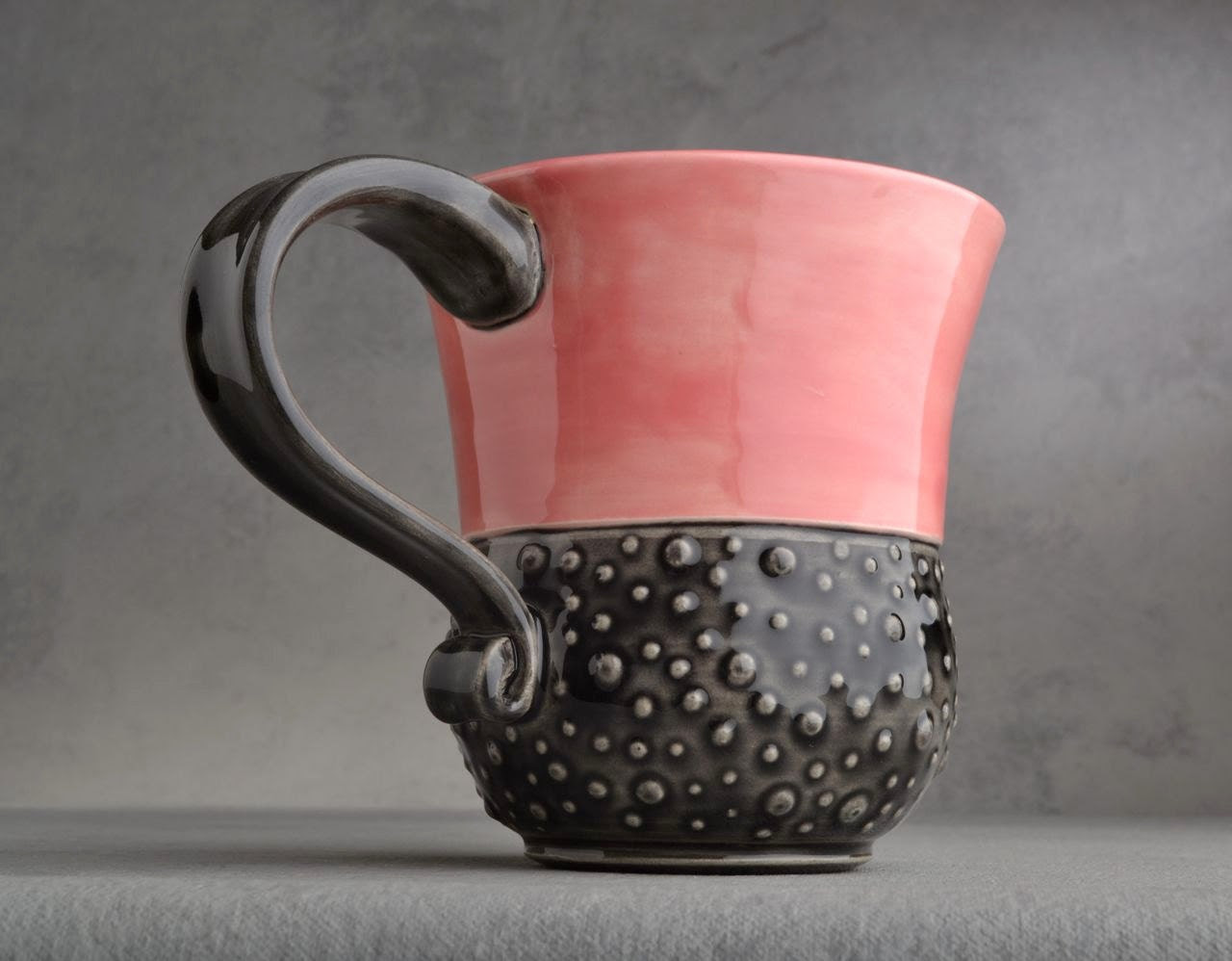 Curvy Dottie Mug: Pink and Clear Black Curvy Dottie Mug by Symmetrical Pottery